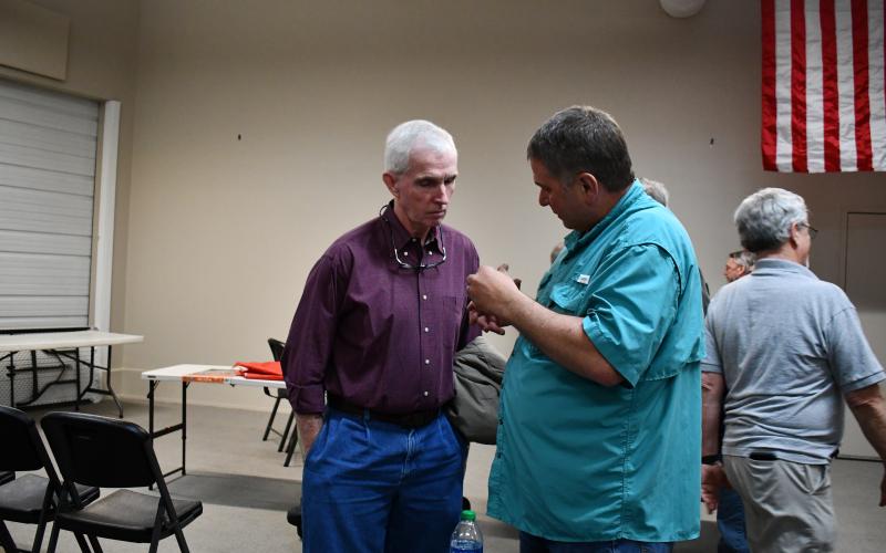 Megan Horn/The Clayton Tribune. Post 2 commission candidate Faron Welch, left, and Post 1 commissioner incumbent Will Nichols converse after the April 11 debate.