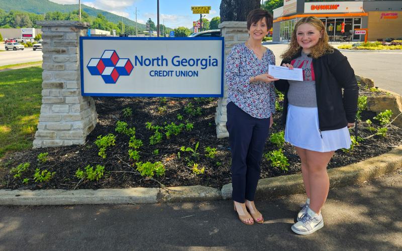Submitted photo. Carrie Kuehne, North Georgia Credit Union member service representative, awards Rabun County High School 2024 graduate Ashlynn Blackwell with the Rabun County scholarship from the local credit union.