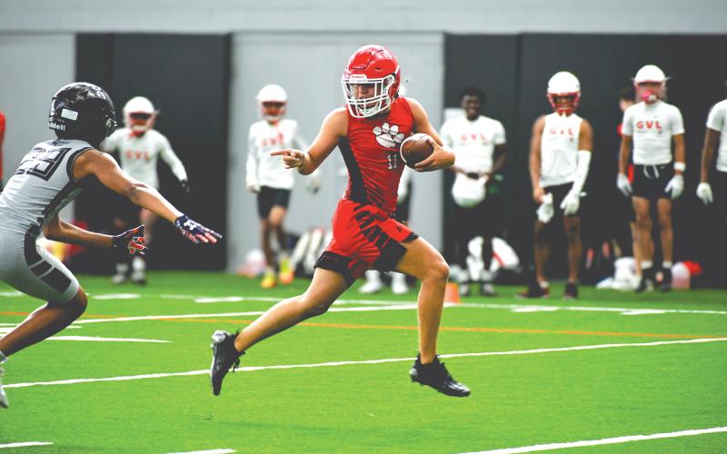 Wade Cheek/The Clayton Tribune. Rabun County football wide receiver Jake Payne speeds by an Alpharetta defender for a touchdown during a 7-on-7 camp at the University of Georgia on Thursday, June 20. The Wildcats played four games within the Bulldogs’ “House of Payne” indoor facility with a number of UGA football coaches and players watching. 