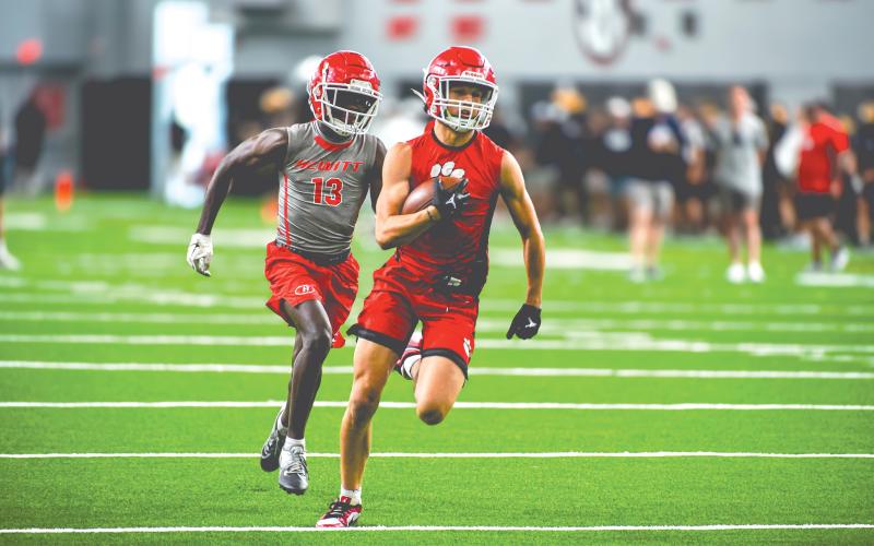Wade Cheek/The Clayton Tribune.  RCHS senior receiver Clay Blalock wins a footrace to the end zone against a Hewitt-Trussville defender. The Wildcats played four games inside the “House of Payne,” the indoor training facility for the University of Georgia football team. 